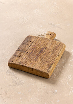 Empty Vintage Wooden Cutting Board on Beige Kitchen Table