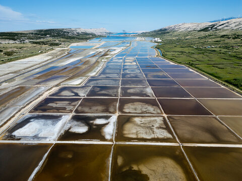 Aerial drone view of Pag Island salt pans or Solana Pag, Croatia. Colorful Salt Evaporation Ponds and Adriatic Landscape