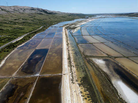 Aerial drone view of Pag Island salt pans or Solana Pag, Croatia. Colorful Salt Evaporation Ponds and Adriatic Landscape