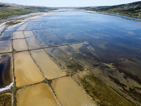 Aerial drone view of Pag Island salt pans or Solana Pag, Croatia. Colorful Salt Evaporation Ponds and Adriatic Landscape