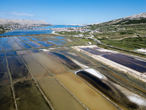 Aerial drone view of Pag Island salt pans or Solana Pag, Croatia. Colorful Salt Evaporation Ponds and Adriatic Landscape
