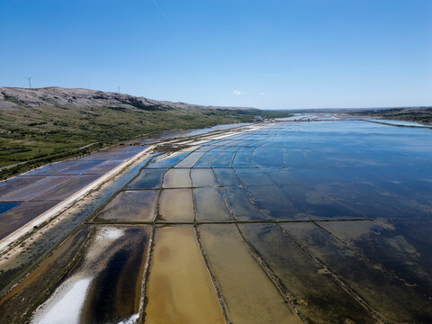 Aerial drone view of Pag Island salt pans or Solana Pag, Croatia. Colorful Salt Evaporation Ponds and Adriatic Landscape