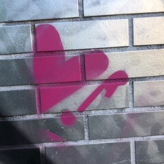 Purple graffiti spray paint heart Pink exclamation mark street art metallic silver brick wall texture © LilliM
