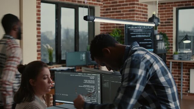 Junior software developer presents source code on a laptop for colleague opinion, supporting collaborative debugging and professional feedback, inside a productive coding environment.