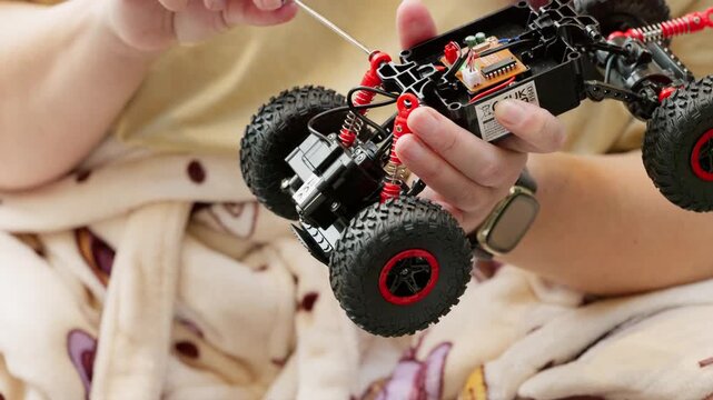 Mother and son on Christmas morning building a new toy car. Following instructions and having festive fun. Complex and intricate construction
