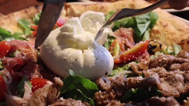 Fresh burrata. It is an Italian cheese with a mozzarella shell and a creamy soft center, known for its rich, milky flavor and smooth texture.