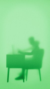 digital nomad typing on his computer through opaque screen