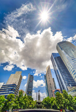 Vertical wide-angle view Mexico City skyline as viewed from the Paseo de la Reforma, on a sunny day.