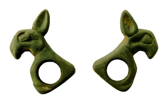Ancient Scythian bronze horse harness plaque showing front and back isolated on white background, saiga antelope animal style artifact.