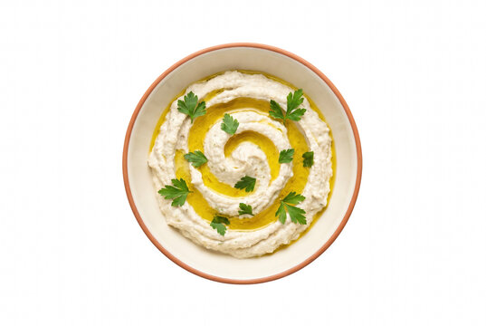 Overhead view of creamy mediterranean dip with olive oil and parsley in a ceramic bowl