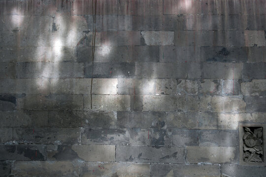 Old weathered stone brick wall with rough textured surface