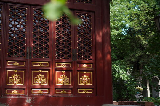 Traditional Chinese Building Door with Lattice Carvings and Golden Decorations