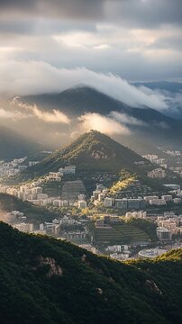 mountain city valley view with misty clouds over hills and skyline