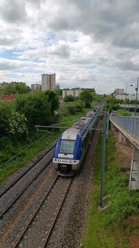 Blue TER Regional Passenger Train Arriving at Railway Station in France