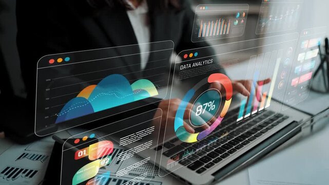 Professional Businesswoman Analyzing Data on Laptop with Advanced Digital Analytics Displays in a Modern Office Environment Sigmoid