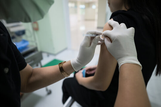Close up doctor hand making vaccination in the shoulder of patient.Flu vaccination injection on arm.Vaccine disease preparing for human papilloma virus.