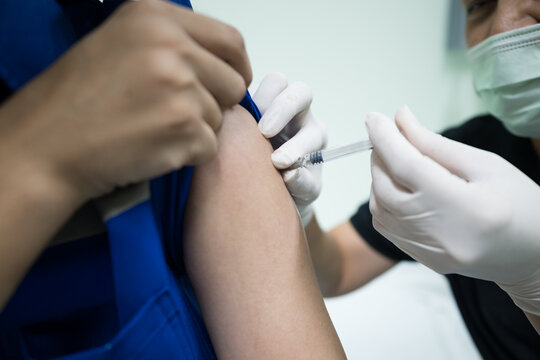 Close up doctor hand making vaccination in the shoulder of patient.Flu vaccination injection on arm.Vaccine disease preparing for human papilloma virus.