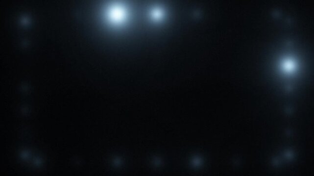 Flashing camera lights and lens flares around frame border on black background