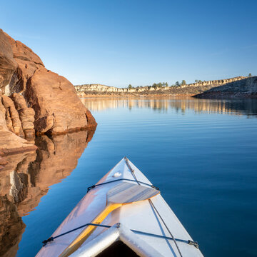 Horsetooth Reservoir at foothills of Rocky Mountains in northern Colorado - POV from expedtion canoe in warm winter scenery