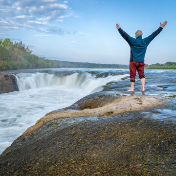 lonely man exercising at the Norden Chute on Niobrara River in Nebraska, late summer sunrise  scenery