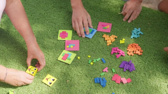 Group of adults playing a mind puzzle game outdoors for mental fitness