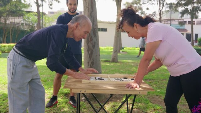 Senior couple improving coordination and balance with a reaction game in a park