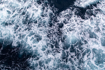 Blue ocean surface with sea foam viewed from above © SHIMA