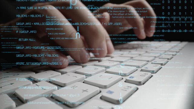 A close-up view of hands typing on a laptop keyboard against a backdrop of flowing code, showcasing the intricate world of technology and information security in modern work environments. Xenic