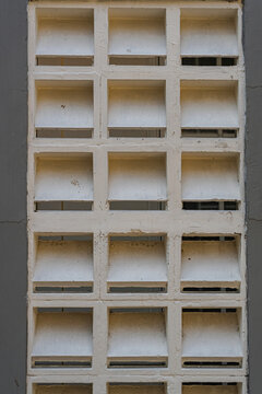 Abstract Geometric Pattern Of White Concrete Ventilation Blocks On A Grey Wall Surface Architecture