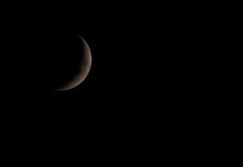 Waxing crescent moon against a dark night sky with copy space © Christine Donnelly