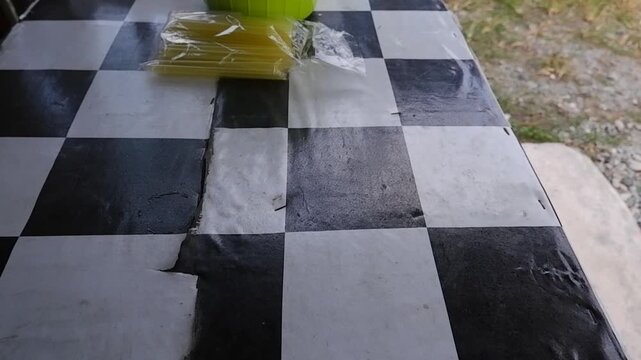 Someone is cleaning the table with a duster