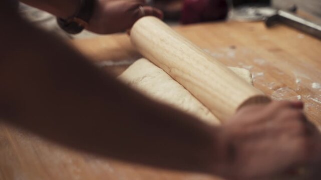 Woman and Man Preparing Dough with Wooden Rolling Pin on White Background in Kitchen for Baking and Cooking Food