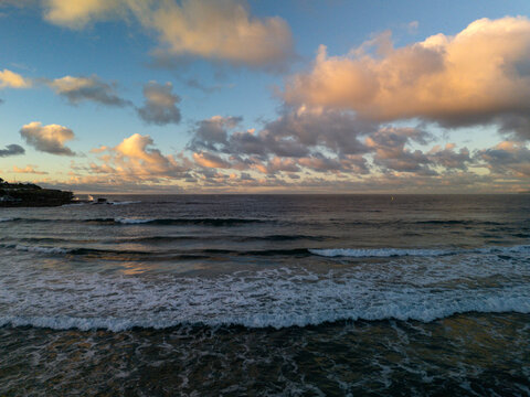 Bondi Beach in early morning with beautiful dramatic sky before sunrise. Panoramic view of beach