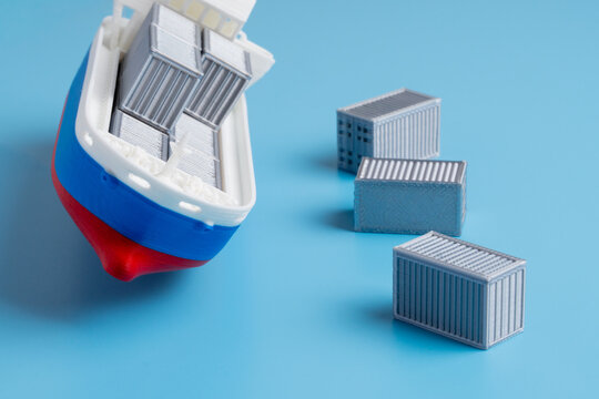 Miniature cargo ship listing heavily, spilling grey shipping containers into a blue background. Maritime disaster, cargo loss, supply chain failure, marine insurance claims concept.