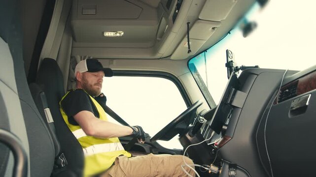 Professional truck driver fastening seatbelt before driving