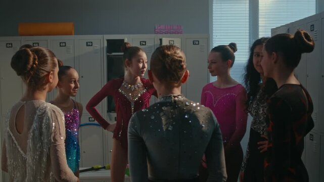 Inside Clean Sports Changing Room, Team of Young Gymnasts Stands in Huddle, Sharing Supportive Moment Before Going Onto Stage. Focused Teen Gymnasts Discussing Performance Plan and Align Mindset.