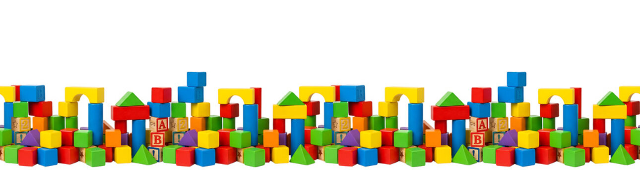 Colorful wooden toy blocks forming a castle like wall.. seamless bord