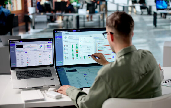 Young IT Manager Reviews Asset Inventory