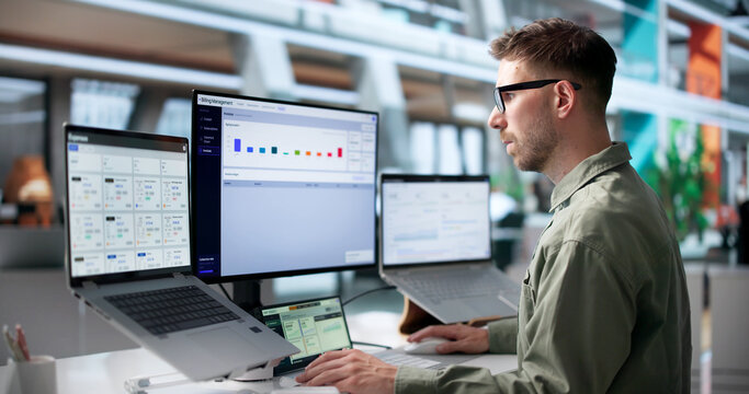 Young Man Uses Laptop To Analyze SaaS Billing