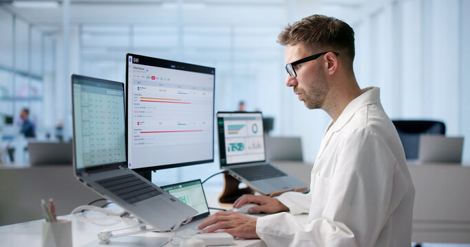 Young Male Doctor Is Reviewing Patient Medical Records