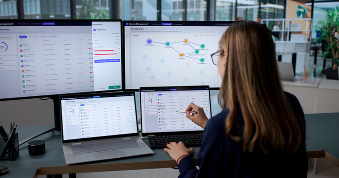 Woman Using Laptop To Manage User Access
