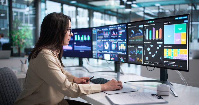 Young Female Financial Analyst Using Computer