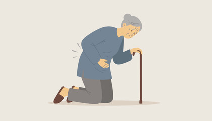 Fototapeta premium Elderly woman kneeling down holds her lower back in severe pain next to her wooden walking cane in a medical concept.