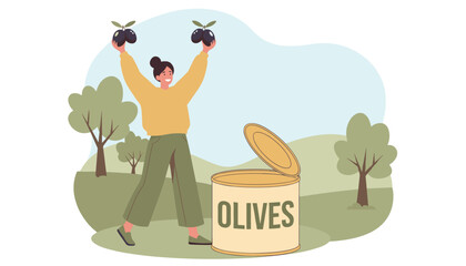 Fototapeta premium Happy young woman holding giant black olives next to a massive tin can in a green countryside landscape.