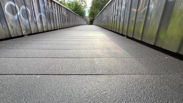 Low Angle Forward Motion Along Urban Pedestrian Bridge with Strong Perspective