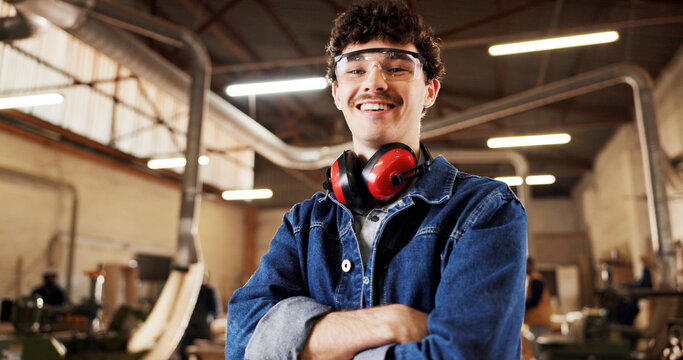 Carpentry, portrait or man in warehouse with arms crossed, craftsman or pride in furniture business. Happy, ppe or carpenter in factory with confidence, woodworking or about us as lumber contractor.