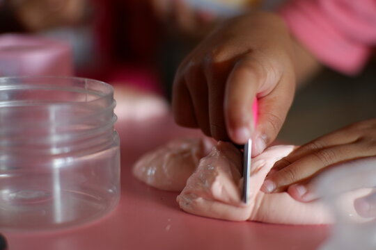 Imaginative role play of a child cooking with play dough