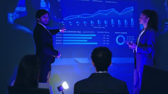 Business presentation data chart team meeting screen analyst office technology projector graph professional group reviewing insights in corporate room blue light audience