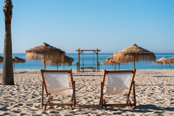 Fototapeta premium Two empty beach chairs face the ocean, inviting relaxation under thatched umbrellas