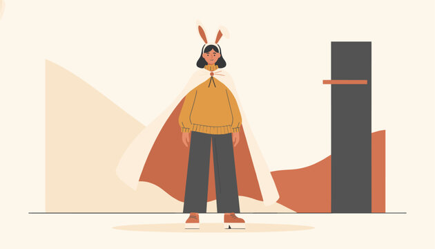 Woman wearing a cozy yellow sweater, dark trousers, white cape, and cute bunny ears standing outdoors against a minimal landscape.